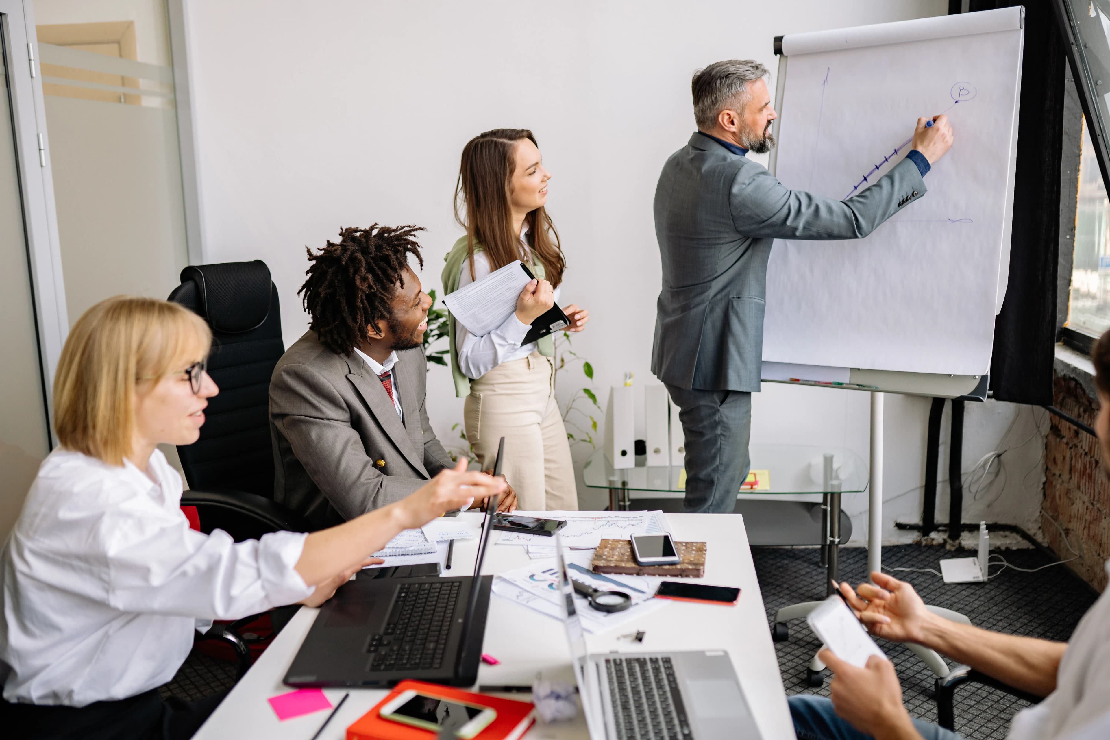 Business owners meeting with a development team around a table to discuss a software project